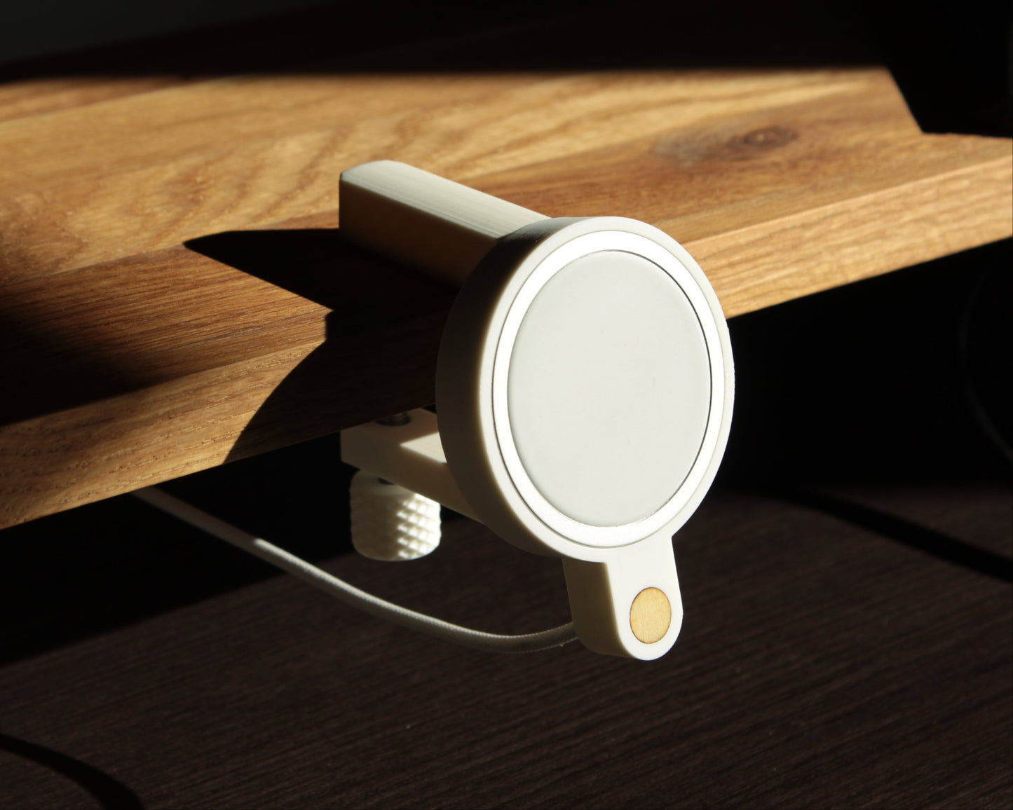 White matte magnetic phone holder on a wooden surface