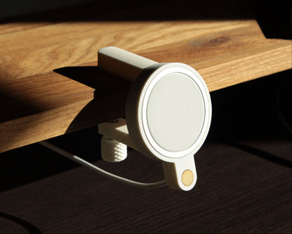 White matte magnetic phone holder on a wooden surface