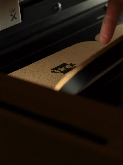 Footage of different Tiles after laser engraving. The modular trays are arranged in modular sets, and they self-align thanks to the built-in magnets. The warm, thick cork base is a distinctive feature, with the Things logo laser engraved at the bottom.